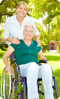 Elder in wheelchair and caregiver smiling