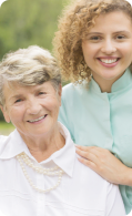 Elder wearing white shirt and a caregiver