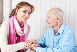 Caregiver and elder holding hands
